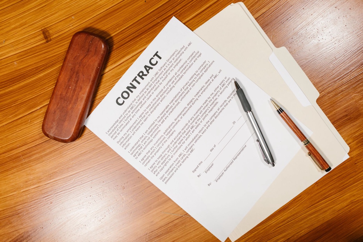A detailed construction estimate and contract on a desk