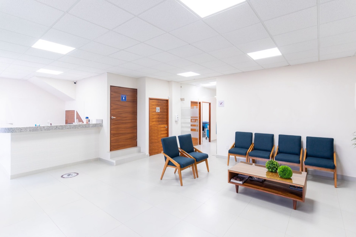 Hospital waiting room with waiting patients and staff