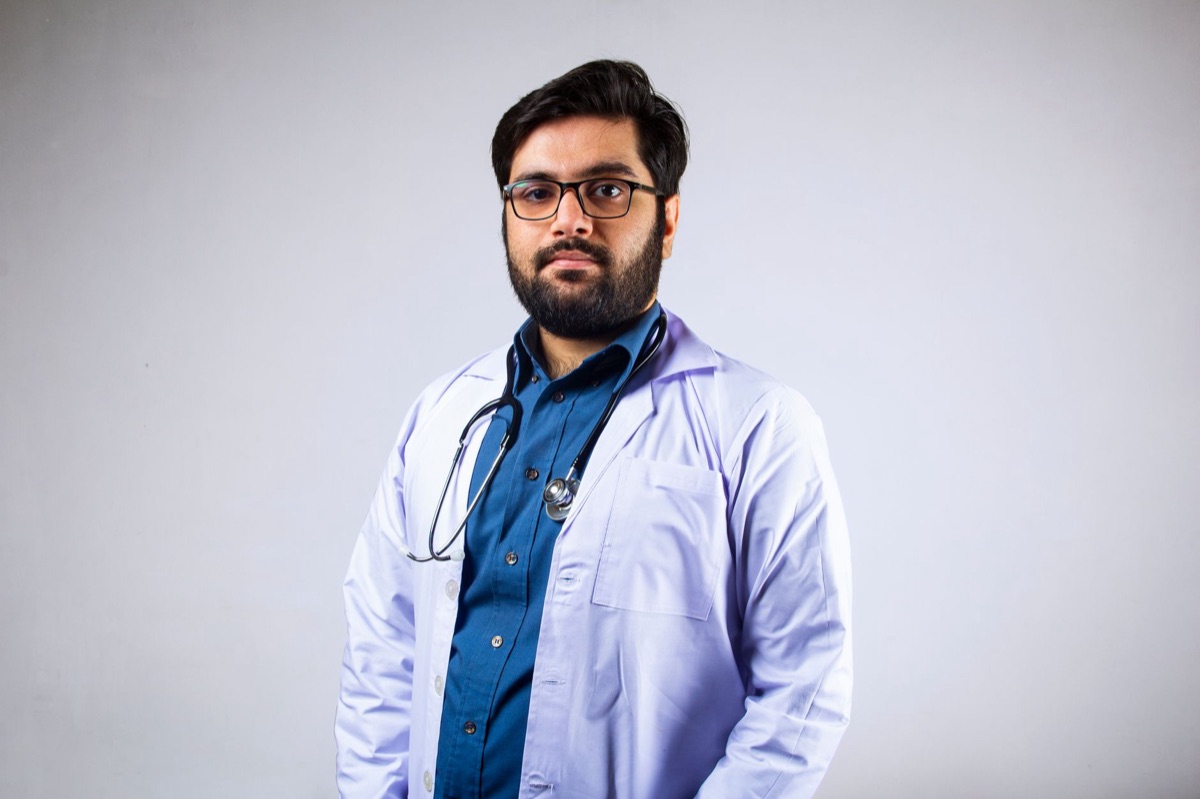 Doctor in white coat standing in a clean, professional medical office